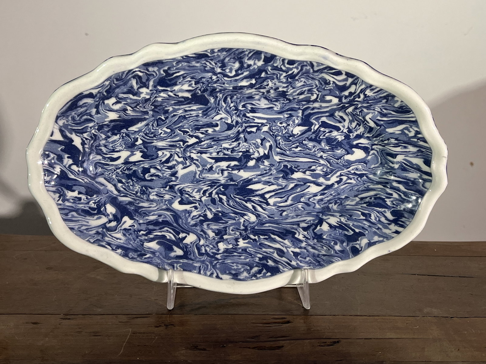 Apt Faience Oval Tray: An oval faience tray from Apt, France, the mottled blue and white clay with a white clay border and clear glaze, signed on reverse "Jo Savalli, Apt".10" w x 6" d