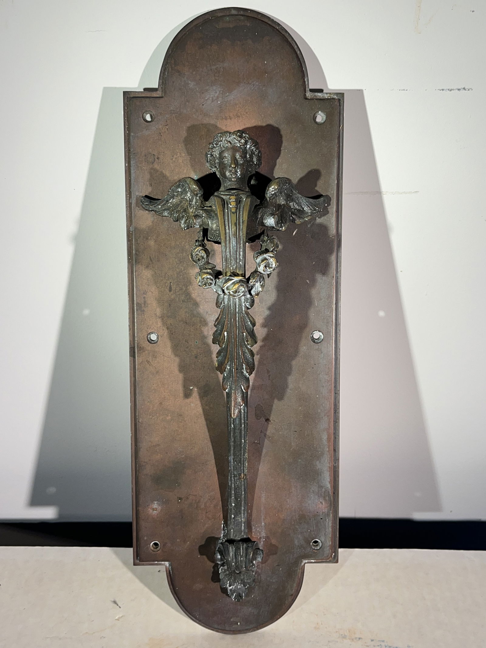 Heavy Bronze Door Handle, 19th Century: A heavy cast bronze door handle and back-plate, early 19th century, in the form of a winged angel.6" w x 3" d x 17" h