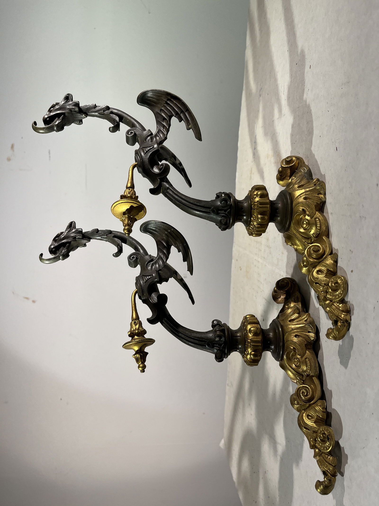 Pair of Finely Cast Wall Brackets, Attr. Caldwell: A finely cast pair of griffon-form wall-hanging brackets in bronze with gilt-bronze decoration, circa 1870, attr. Caldwell.10" w x 3" d x 10" h