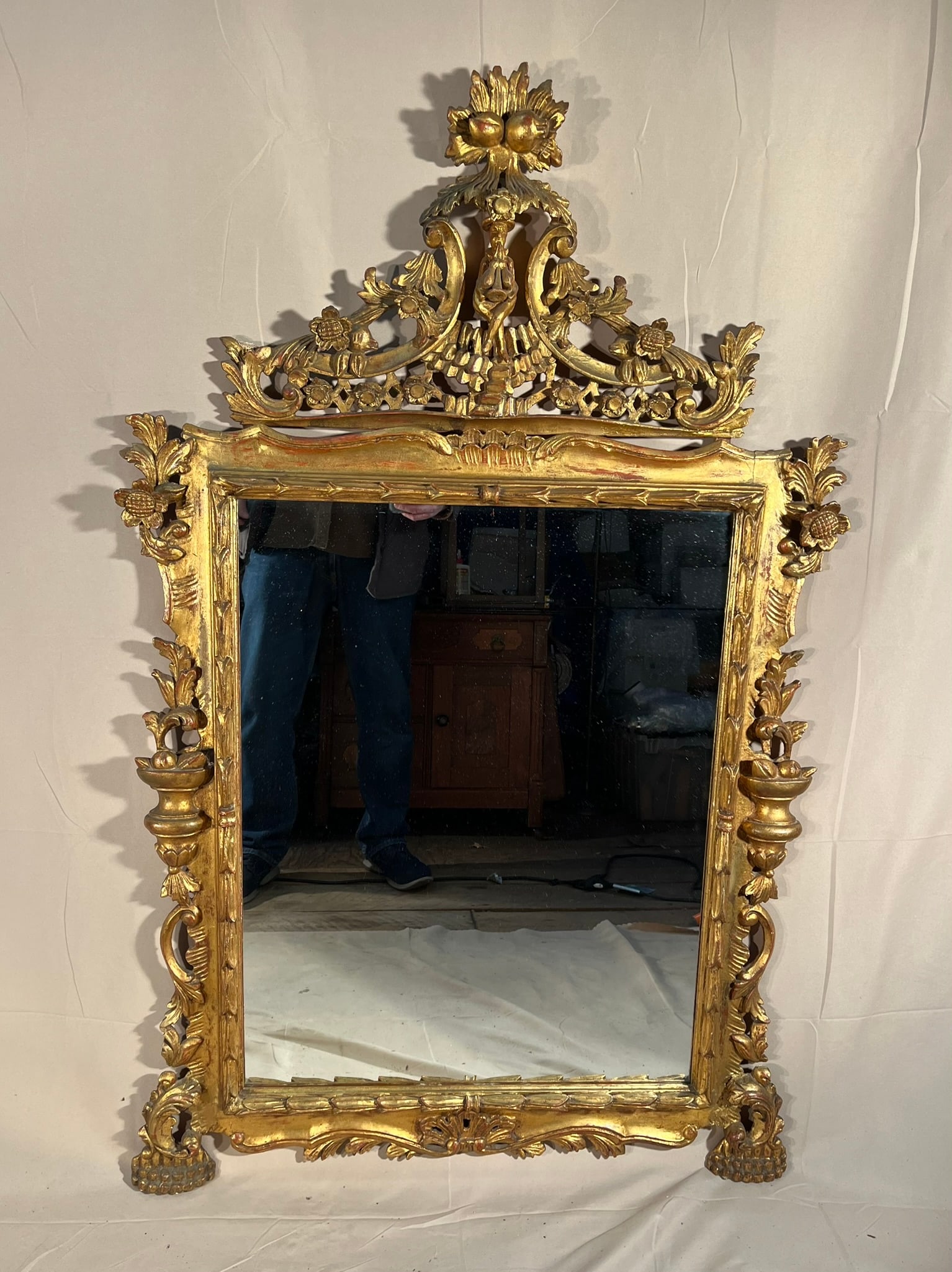Giltwood Louis XV Style Mirror: A giltwood Louis XV style mirror with elaborately carved frame, 20th century. 52" h x 32" w