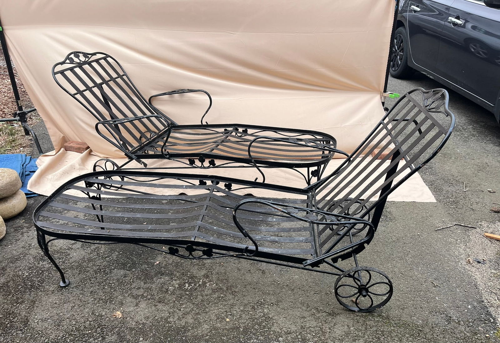 Pair of Wrought Iron Chaise Lounges: A pair of mid-century wrought iron chaise lounges with wheels, 32" h x 66" w x 30" d