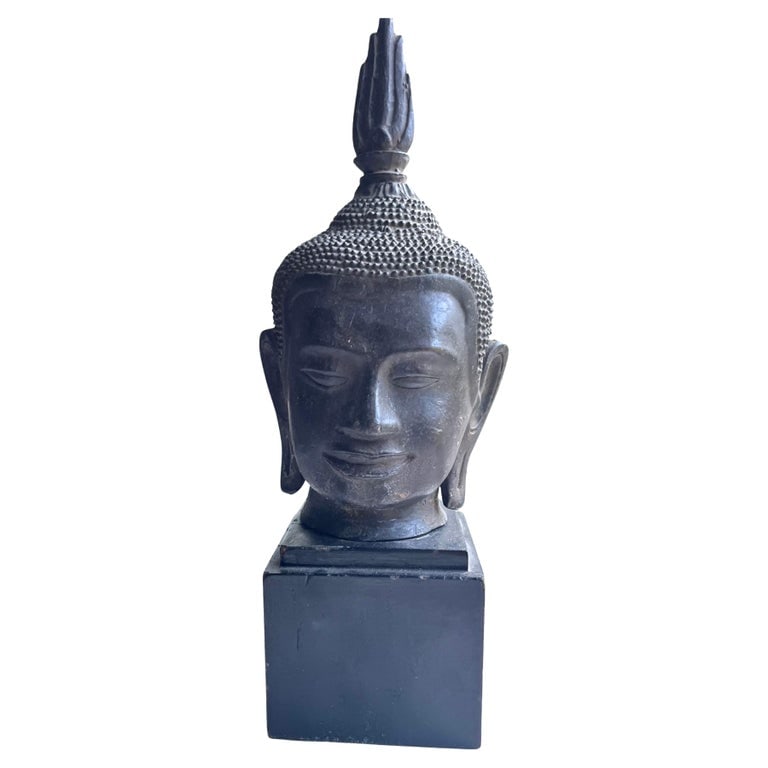 Thai Buddha Head, Bronze: An antique Thai Buddha head in bronze, mounted on a wooden base.5" x 5" x 14" overall h