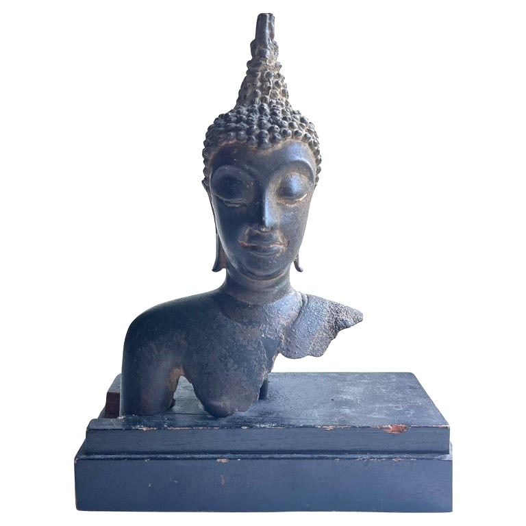 Thai Buddha Head, Bronze: An antique Thai Buddha head fragment in bronze, mounted on a wooden base. 3" d x 5" w x 7" h overall