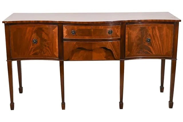 Federal Style Mahogany Sideboard: A Federal style mahogany sideboard with side cabinets flanking a center drawer.