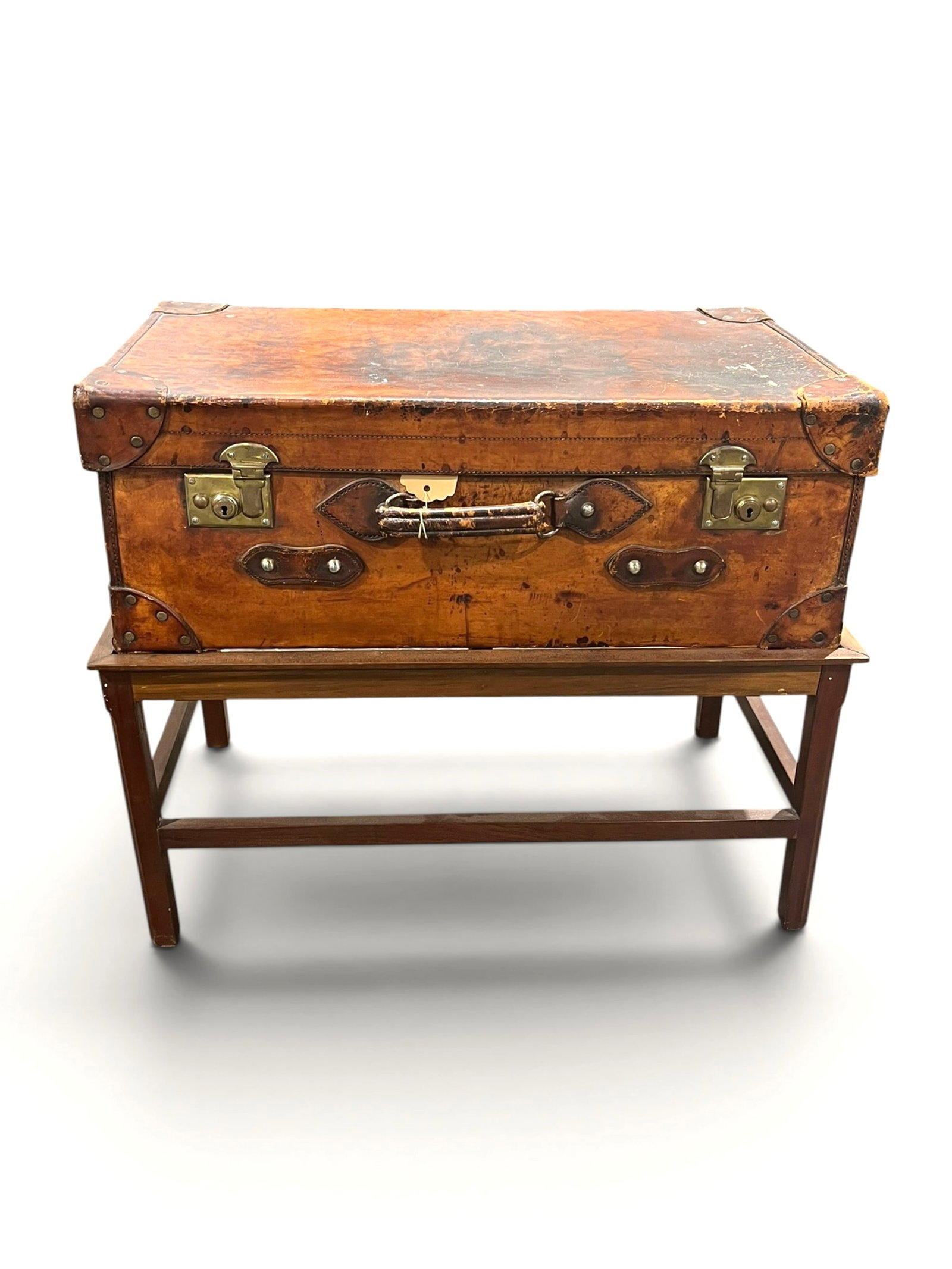 Antique Leather Trunk on Stand: An antique leather trunk or suitcase on a custom-made stand. 28" w x 16" d x 23" h with stand