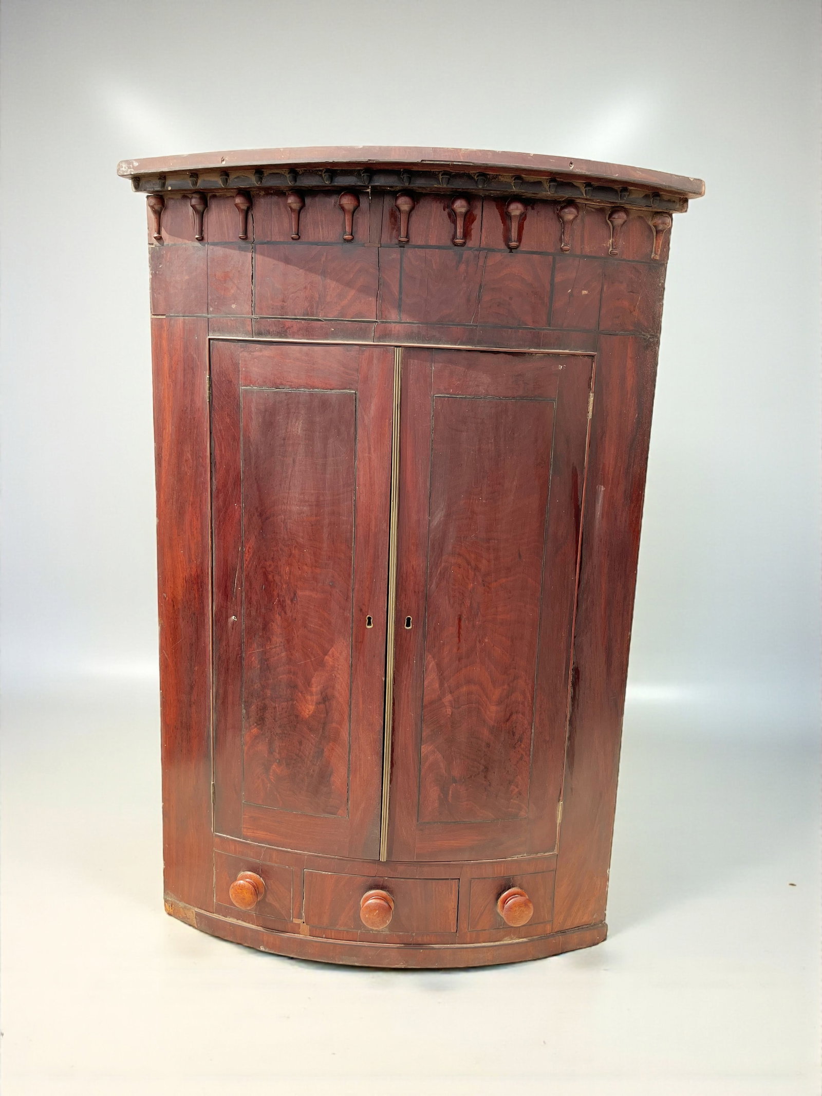 Hanging Corner Cabinet: A demilune hanging corner cabinet in mahogany, with inlaid decoration, mid 19th century. 22" x 22" x 52" h