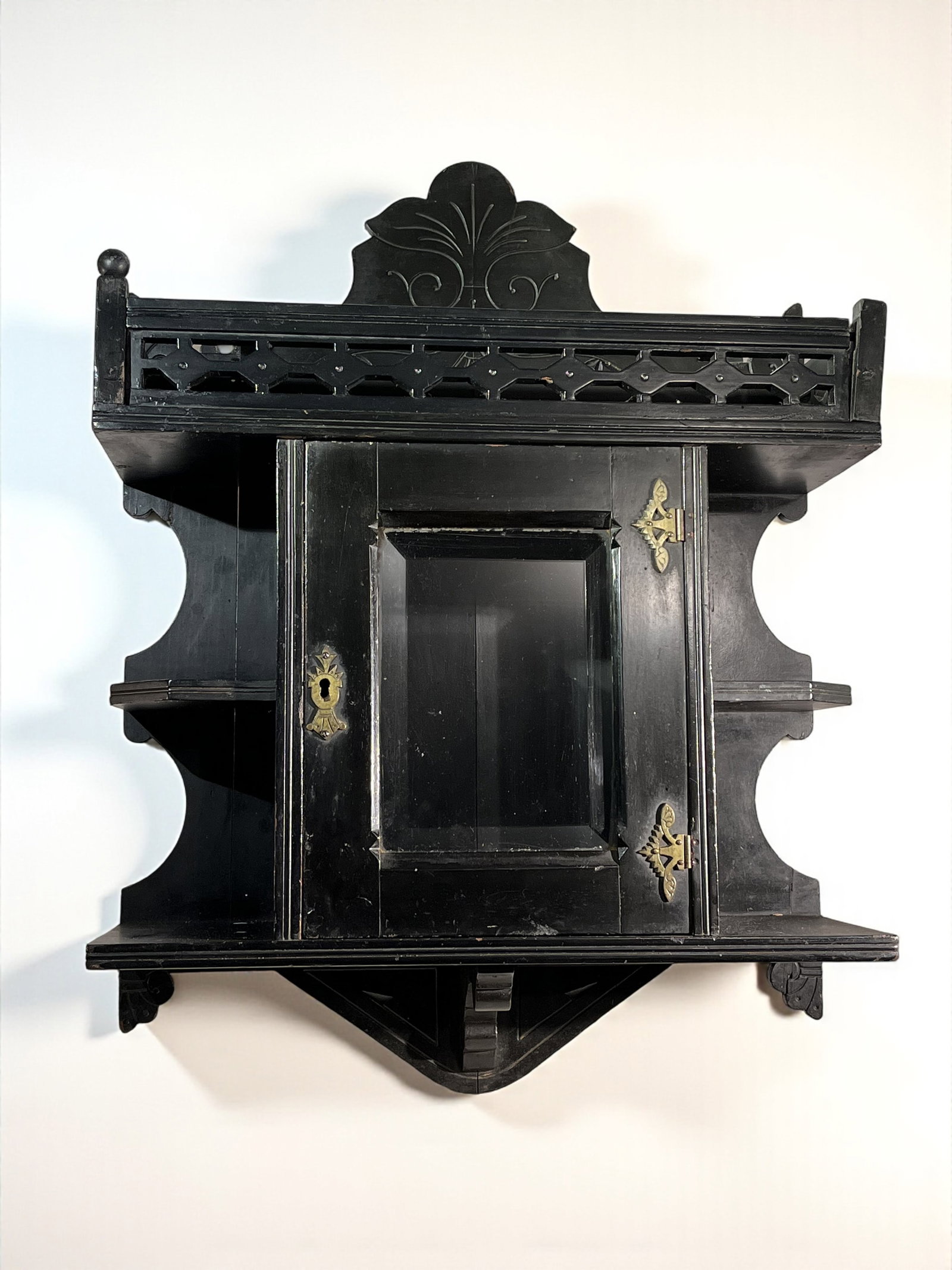 Aesthetic Revival Wall Cabinet: An aesthetic revival cabinet in ebonized wood with beveled glass door. 7" d x 19" w x 26" h