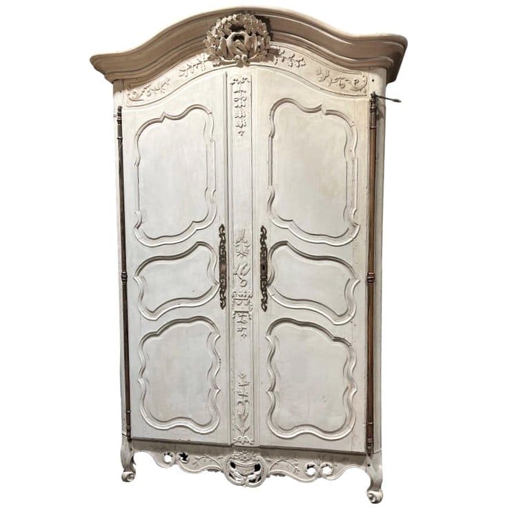French Louis XV Provencale Armoire: An impressive Louis XV period wedding armoire circa 1760 from Provence, with elaborately carved case with love birds, flowers, garlands and hearts beating on a drum. In distressed grey painted