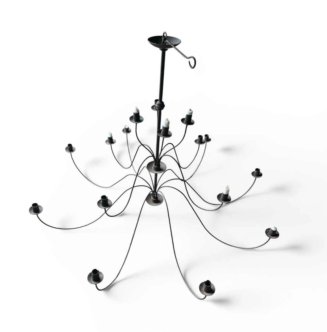 16-Candle Iron Chandelier: A 16-candle "spider" chandelier, retailed by Pierre Deux, circa 1980. Unelectrified. 48" dia. x 36" h Can be disassembled for shipping.