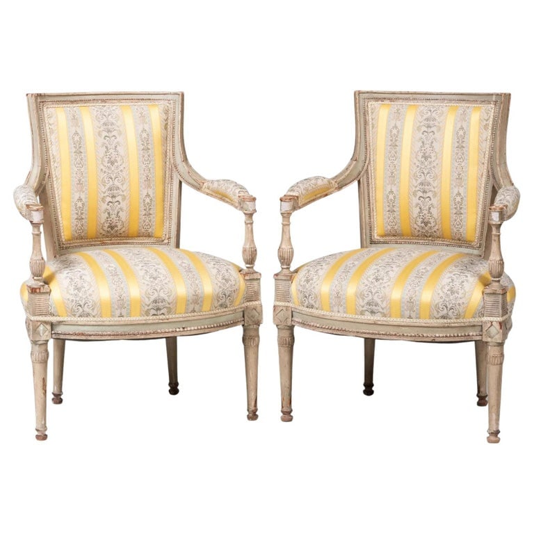 Pair of French Directoire Armchairs, Circa 1810: A pair of French Directoire fauteuils in original light grey painted finish, circa 1810, upholstered in silk fabric. 23" w x 20" d x 32" h.