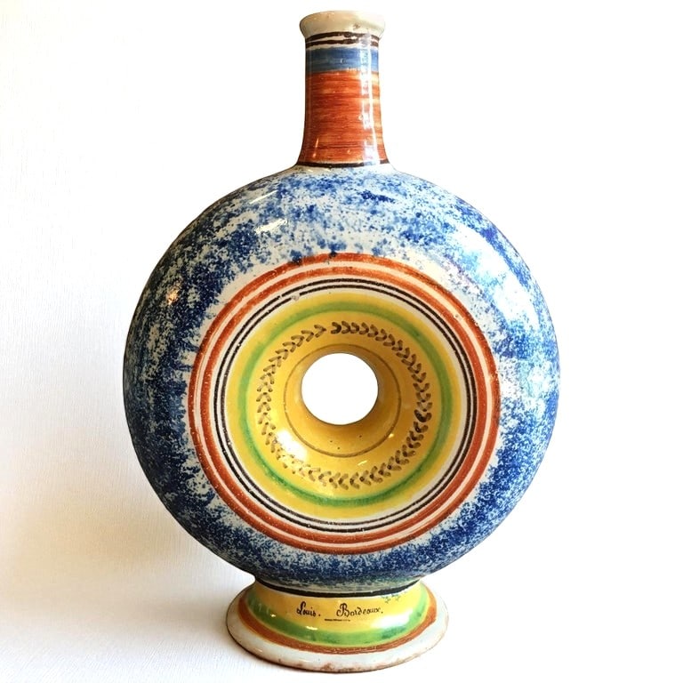 French Faience Bottle, Dated 1838: A rare early 19th century French faience circular form bottle with sponge glaze decoration and bearing the inscrition "L'an 1838" on one side and "Louis Bordeaux" on the opposite. From the personal co