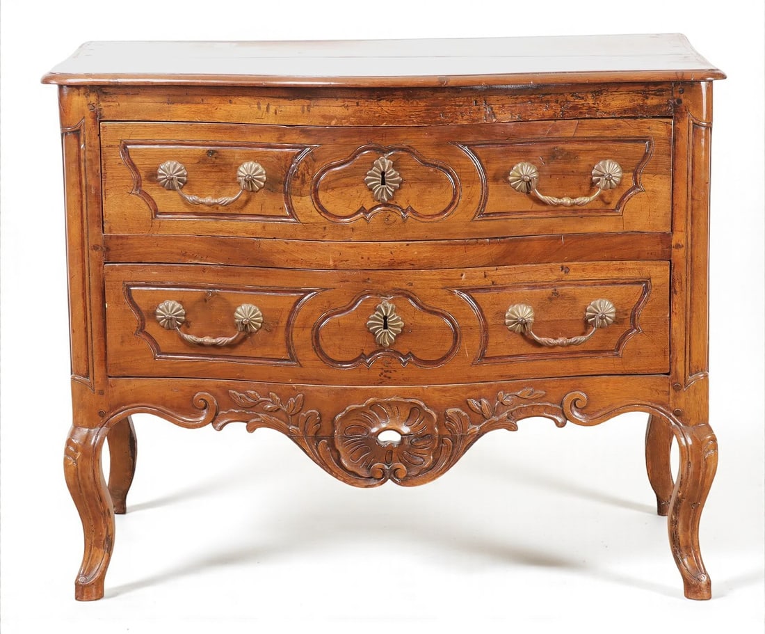 French 18th Century Louis XV Commode: A petite Louis XV period Provencale commode in fruitwood, with 2 drawers, brass hardware a carved and pierce apron on cabriole legs. Circa 1780. 21" d x 40" w x 31.5" h