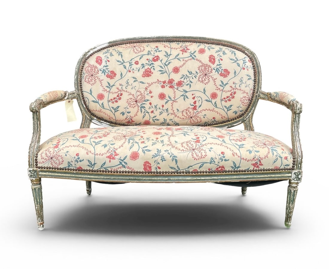 French Louis XVI Style Settee, Painted: A French Louis XVI style settee in distressed painted finish, upholstered seat and back, circa 1900. 49" w x 28" d x 35" h