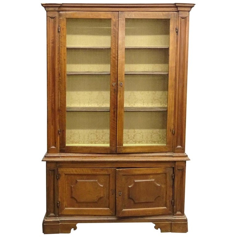 French Louis XVI Bookcase: A French Louis XVI biblioteque in walnut, with wire grill upper doors and paneled lower doors, circa 1800, working lock with key. 17" d x 54" w x 84" h One piece.