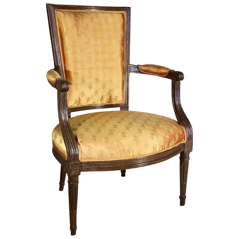 French 18th Louis XVI Fauteuil: A French 18th century Louis XVI fauteuil in stained beech, upholstered seat and back, circa 1790. 22.5" x 22.5" x 34.5" h