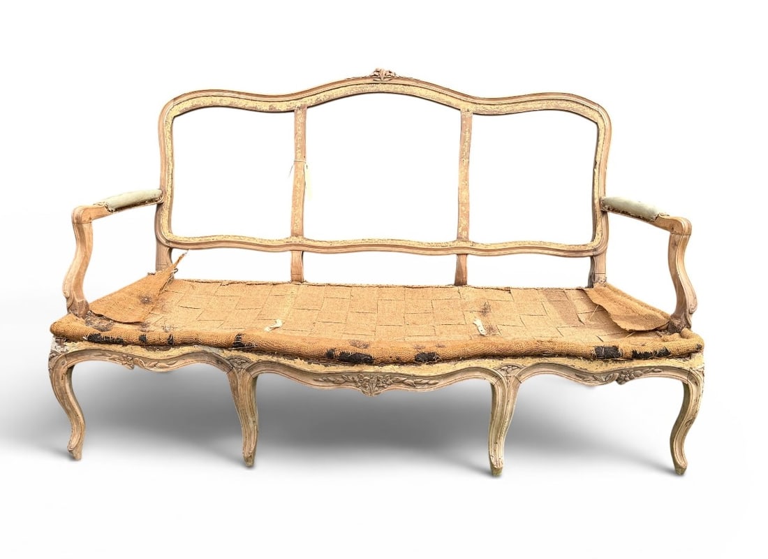 French 18th Louis XV Canape Frame: A French 18th century Louis XV canape frame in stripped beech, circa 1760, carved back and seat rails with floral bouquets, on carved cabriole legs. 31" d x 63" w x 39" h