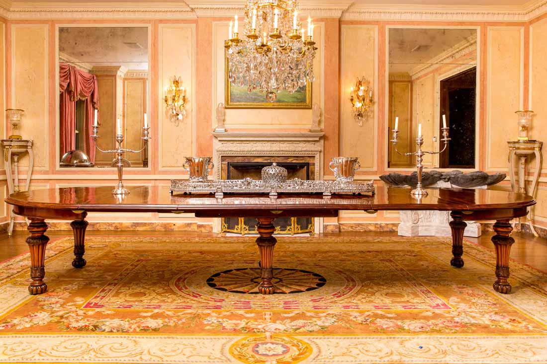 Antique English Dining Table: Carved mahogony oval dining table with 6 carved and turned legs. Includes 7 matching 2' leaves England c.1830 29"H x 64" W; table extends from 65" to 233" Condition: Good