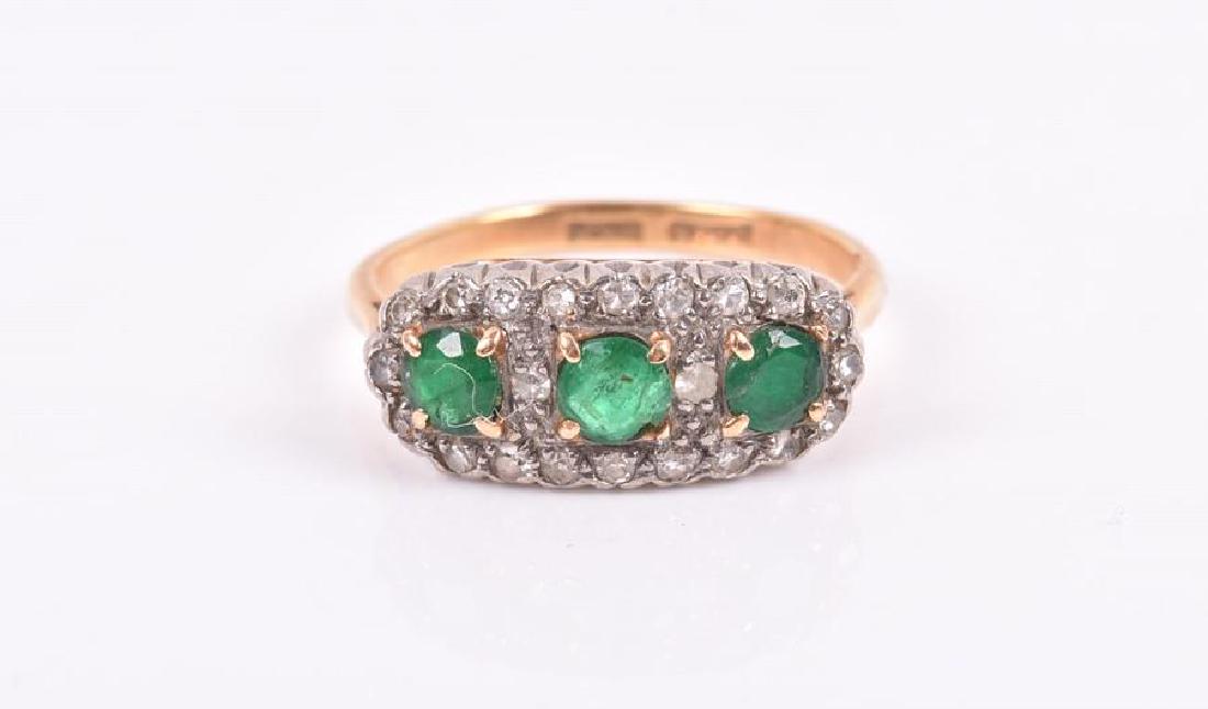 An 18ct yellow gold, diamond, and emerald cluster ring (1 of 3)