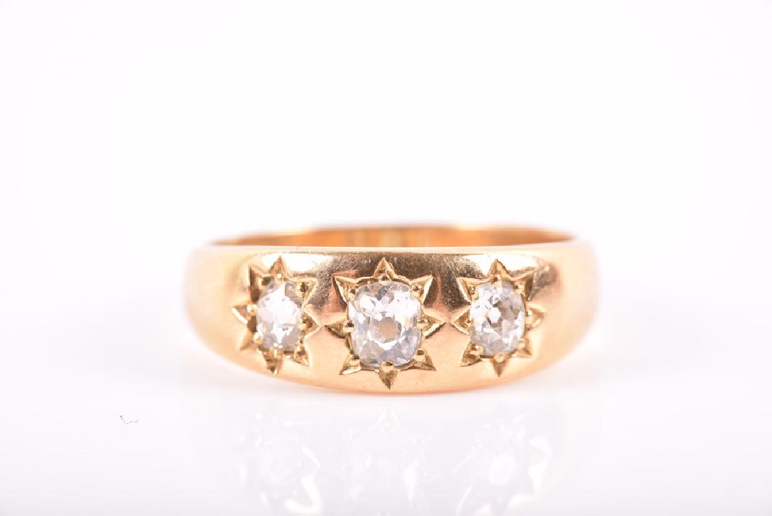 A yellow metal and diamond ring  inset with three (1 of 2)