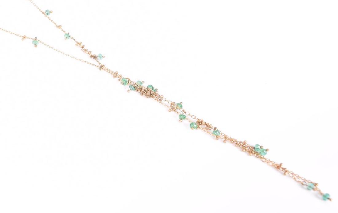 A yellow metal and emerald opera-length necklace with: A yellow metal and emerald opera-length necklace with varied length gold tassel drops strung with faceted emerald beads, unmarked (tests as 18ct yellow gold), 5.7 grams.