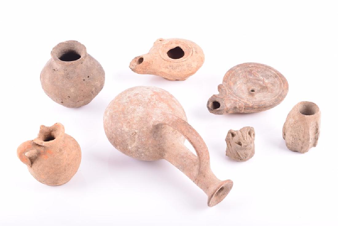 A Eastern Mediterranean oil lamp with sgraffito design: A Eastern Mediterranean oil lamp with sgraffito design possibly 3rd century BC, along with a Roman lamp, 2nd century AD and a collection of five further artefacts. (6).