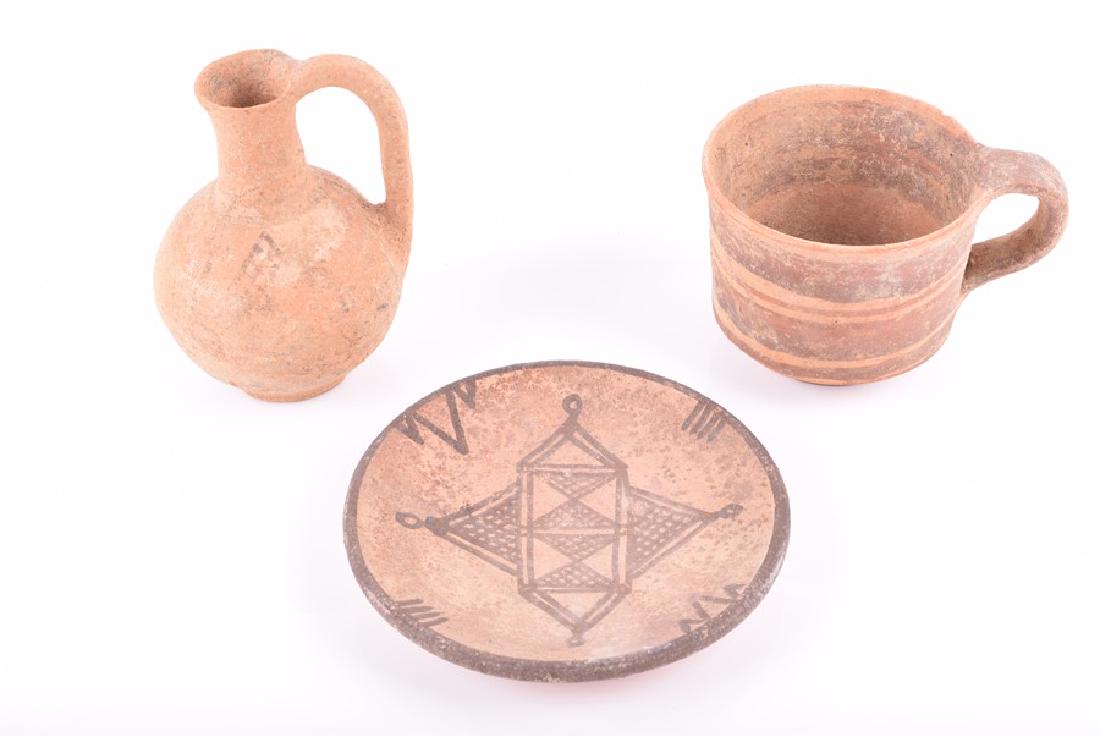 Three pieces of Cypriot Black on Redware, possibly Iron: Three pieces of Cypriot Black on Redware, possibly Iron Age IIA circa 900 BC, the small burnished cup is decorated with banding and is possibly 7th century BC (Cypro-Archaic Period), the plate de