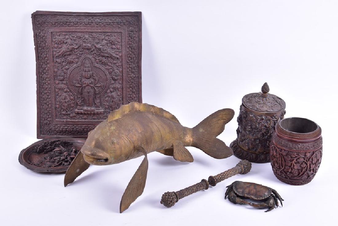 A large Oriental brass model of a fish together with a: A large Oriental brass model of a fish together with a copper plated model of a crab with real shell underneath, a carved Indian hardwood tobacco jar, a large Indonesian large relief plaque of the god
