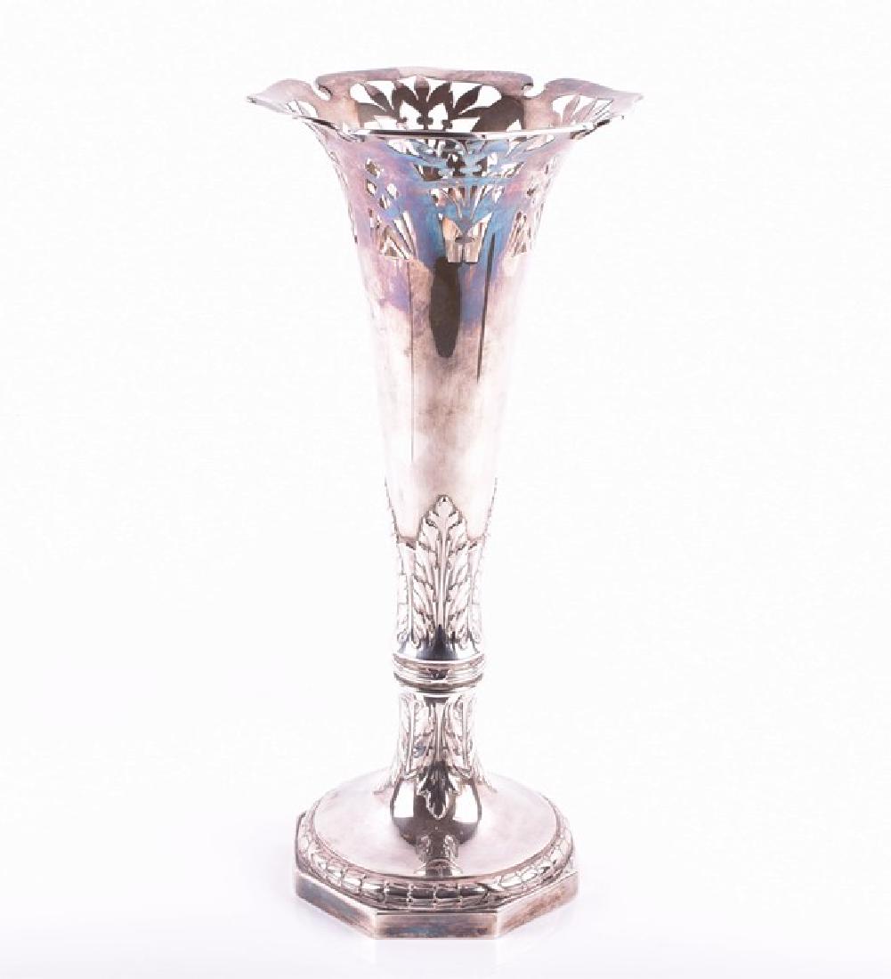 A German Art Nouveau silver vase stamped 800, the: A German Art Nouveau silver vase stamped 800, the fluted neck pierced with floral patterns in the secessionist style, the tapered body decorated with acanthus leaves opens to a octangular base, 19.4 o