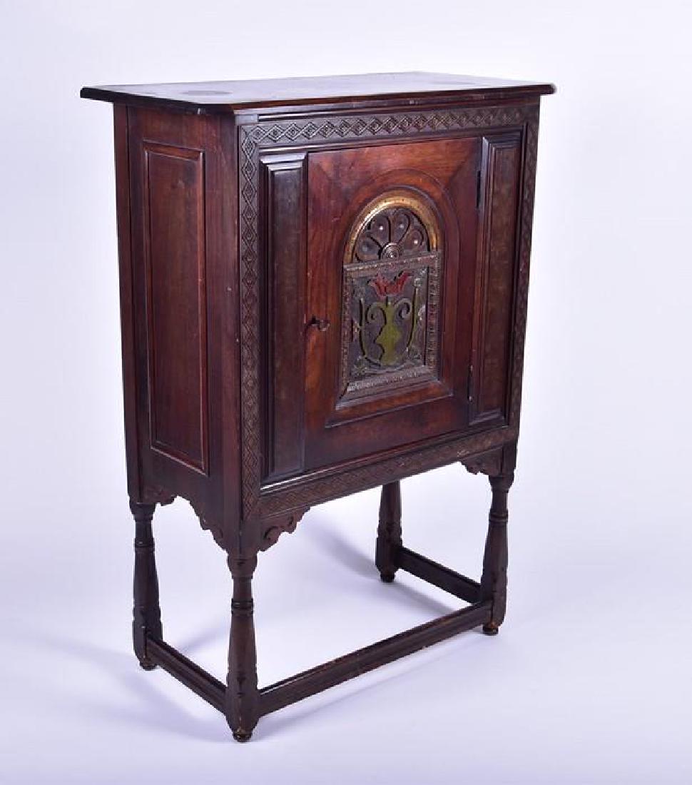 An early 20th century American folk art cabinet the: An early 20th century American folk art cabinet the single cupboard door with relief carved and painted decoration in the Art Nouveau style, 116 cm high x 82 cm wide x 40 cm.