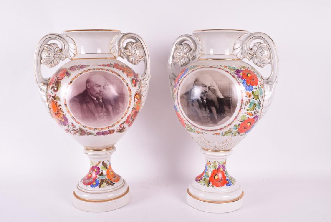 A pair of Russian porcelain urns the bodies decorated: A pair of Russian porcelain urns the bodies decorated with garlands of floral bouquets, the front cartouches with a portrait of Vladimir Lenin, 47 cm x 32 cm. Provenance: Iconastas Gallery, Picc