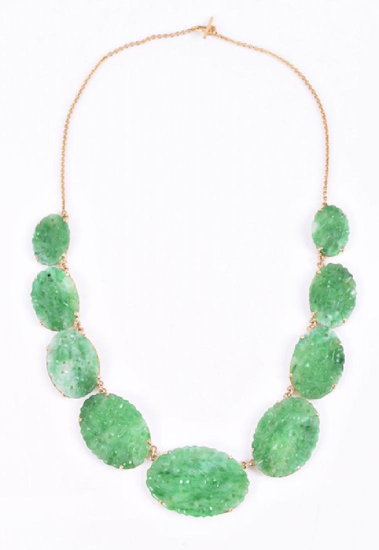 A Chinese yellow metal and jade necklace comprised of: A Chinese yellow metal and jade necklace comprised of nine graduated plaques with pierced and reticulated decoration, the largest 3 cm wide, the smallest 1.8 cm wide, set in unmarked yellow metal (tes
