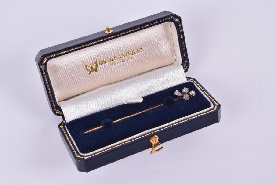 A diamond cluster tie pin  set with a trefoil clover of (1 of 3)