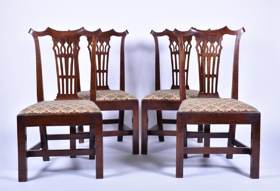 A set of four George III mahogany chairs in the: A set of four George III mahogany chairs in the pagoda style, after a design by Thomas Chippendale, each with embroidered seat.