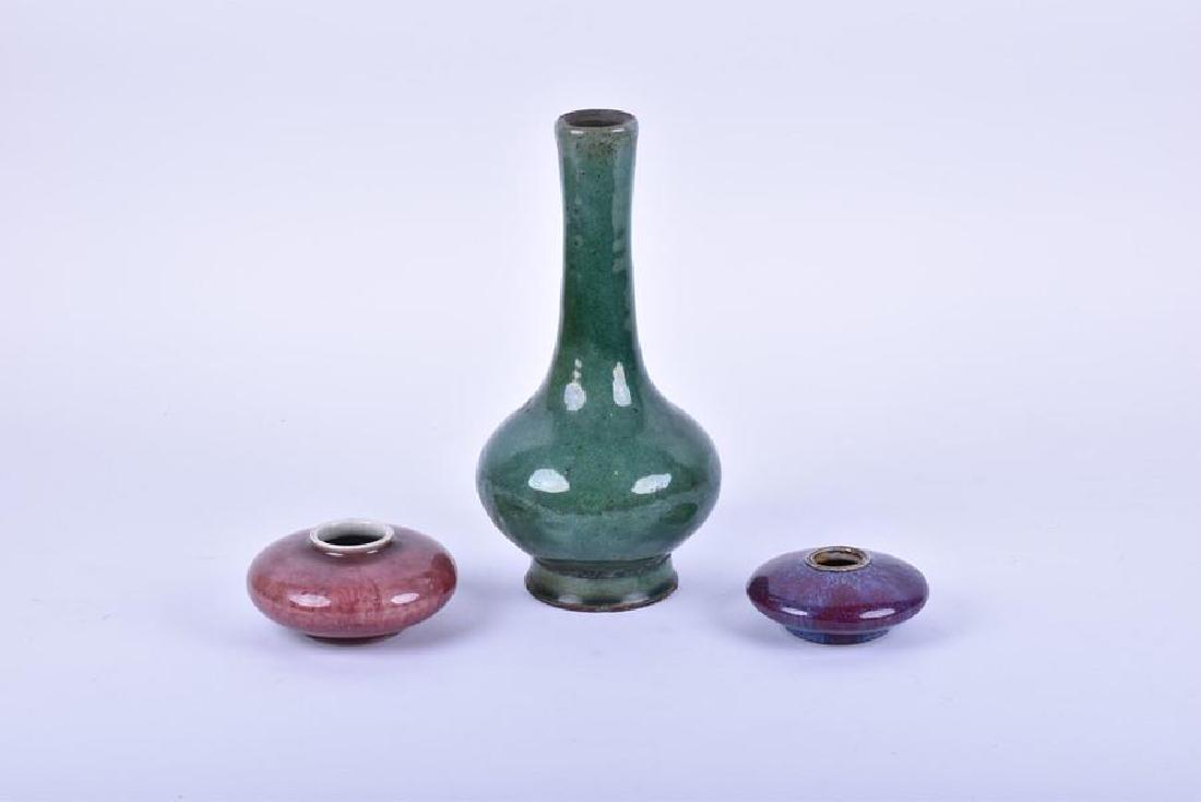 Two Chinese Qing dynasty sang de boeuf flambe brush: Two Chinese Qing dynasty sang de boeuf flambe brush washers to include one with vivid purple and blue mottled glaze, the other with a peach blossom glaze and underglazed scroll pattern, both of squat 