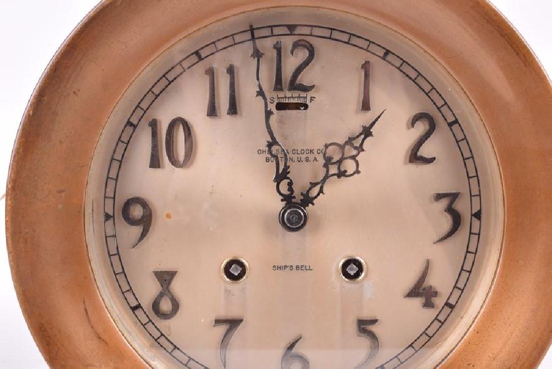 An early 20th century American Chelsea Clock Co. mantel: An early 20th century American Chelsea Clock Co. mantel clock, with brass case, the barrel body containing the movement on a tapered foo, the base impressed 139179, 26 cm x 24 cm.