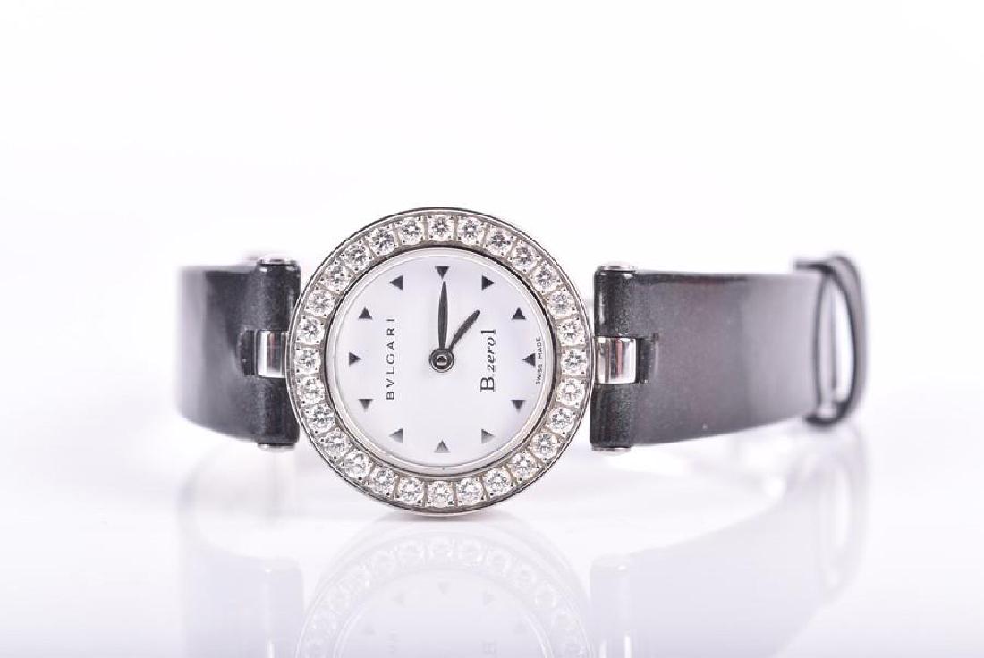 A Bulgari Bzero1 ladies stainless steel wristwatch the: A Bulgari Bzero1 ladies stainless steel wristwatch the white dial with small arrow shaped hour markers, and stone-set bezel, with concealed crown, on a patent leather strap with deployant clasp. 22 mm