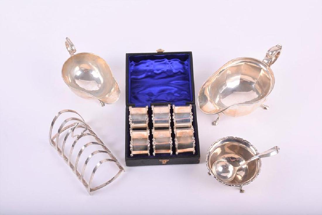 A miscellaneous collection of silver Sheffield &: A miscellaneous collection of silver Sheffield & Chester 1911 - 1934, various makers, comprising: two sauce boats, a toast rack, a sugar bowl, a sugar spoon and a cased set of six napkin rings, each n