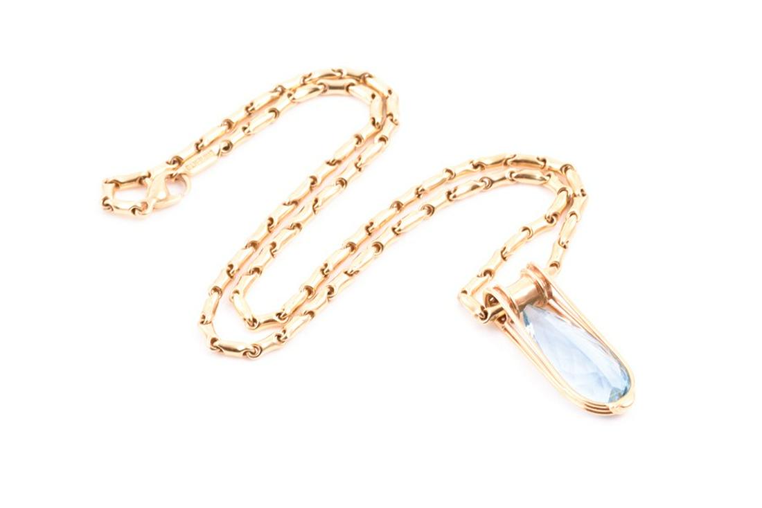 Chimento, Italy. An 18ct yellow gold, diamond, and: Chimento, Italy. An 18ct yellow gold, diamond, and aquamarine pendant set with an elongated pear-cut aquamarine, within a looped gold setting, the mount inset with round brilliant-cut diamonds, on or