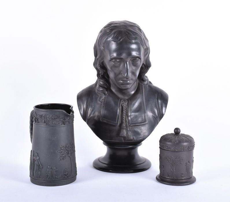 A late 19th century Wedgwood black basalt library bust: A late 19th century Wedgwood black basalt library bust of Milton by E.W. Wyon for Wedgwood, modelled as the English poet John Milton, mounted on a short wasted circular socle, impressed to the back of