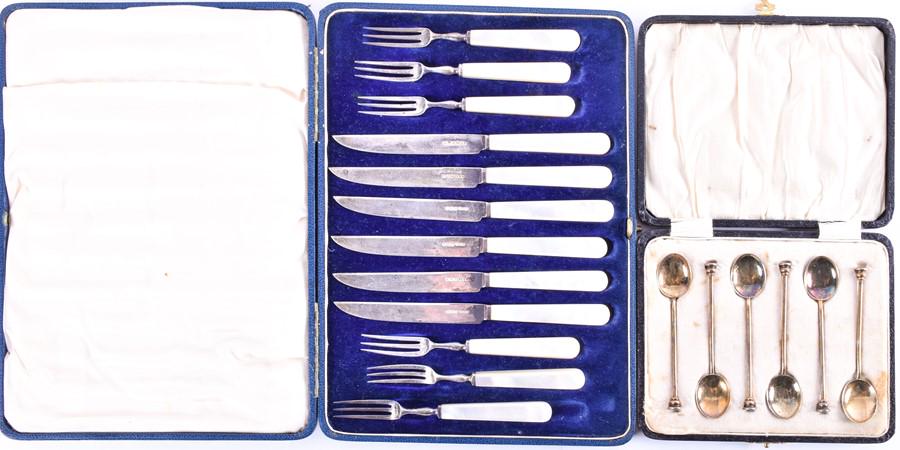 A cased set of six silver gilt and guilloché backed: A cased set of six silver gilt and guilloché backed coffee spoons Birmingham 1932, by William Suckling Ltd, together with a cased set of mother of pearl handled fruit knives and forks, Sheffield 1932