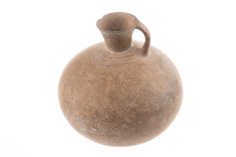 A Persian antique single handle terracotta vessel of: A Persian antique single handle terracotta vessel of bulbous form with flared rim and stippled decoration around the base of the handle and top of the body, 16 cm x 16 cm.