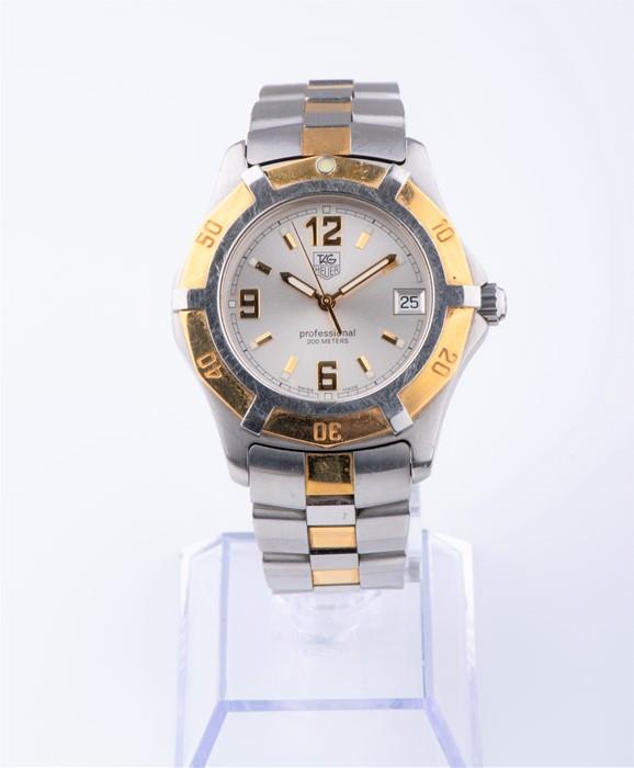 A Tag Heuer Professional stainless steel and gold: A Tag Heuer Professional stainless steel and gold wristwatch the silvered dial with gilt numerals and baton markers, with date aperture and rotating bezel, on a stainless steel bracelet with deploymen
