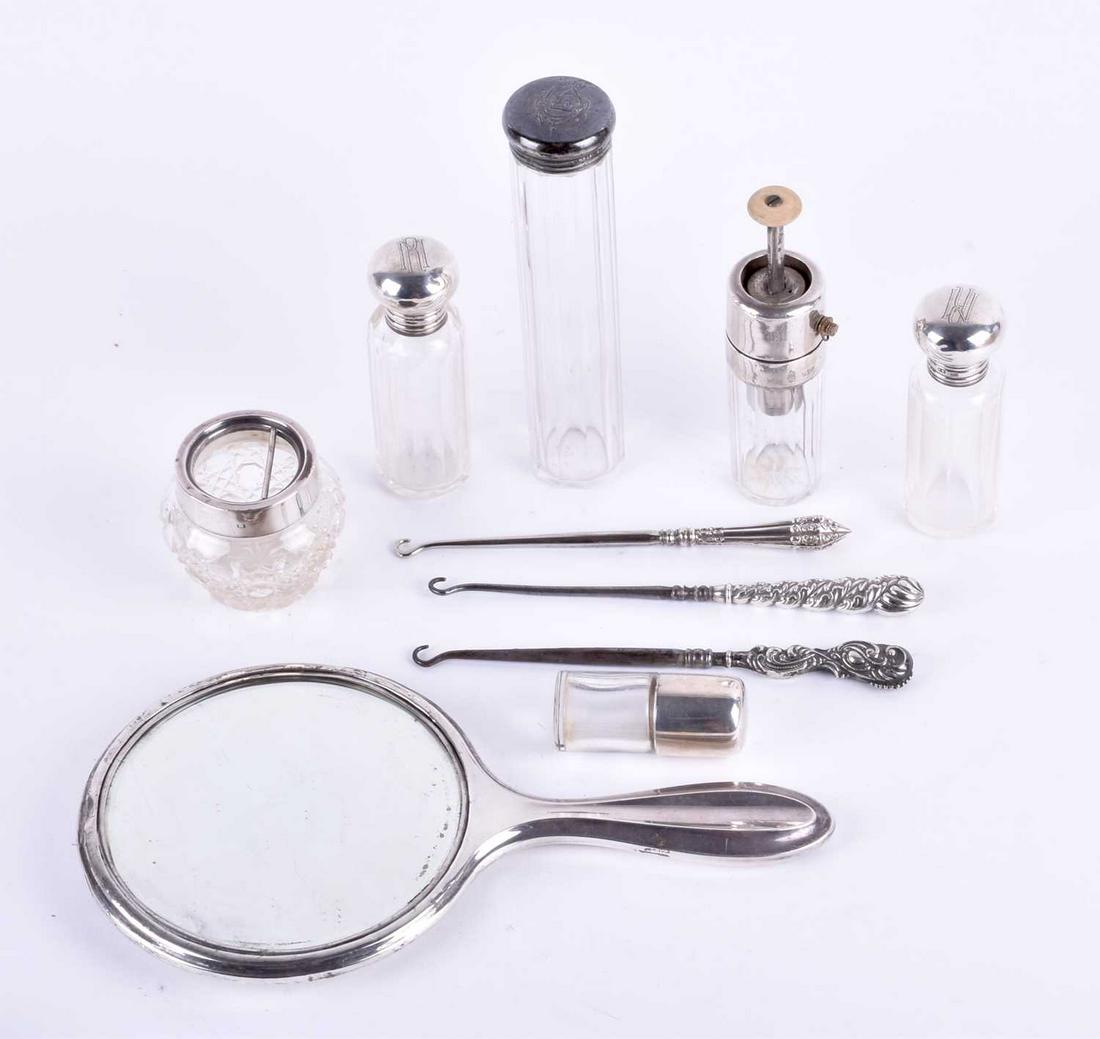 A collection of silver topped dressing table: A collection of silver topped dressing table accessories comprising four bottles, an atomiser, a hair tidy and a hand held mirror, together with three silver handled button hooks (Qty: 10)Qty: (10)