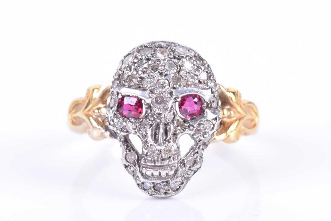 A yellow metal, silver, and diamond 'skull' ring the (1 of 4)