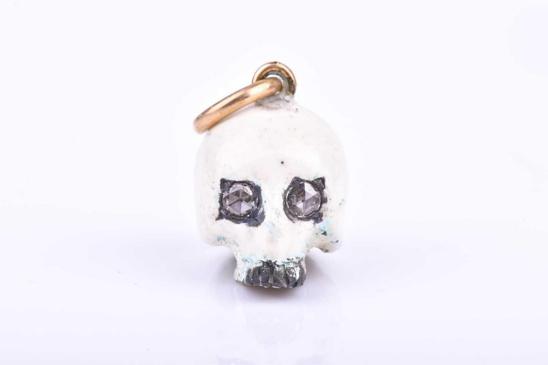 An unusual silver and enamel skull pendant, set with (1 of 3)