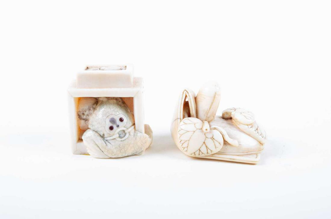 Two Japanese ivory netsukes, Meiji, carved as a: Two Japanese ivory netsukes, Meiji, carved as a dignitaries hat covered with three lotus leaves, signed, 3.7cm wide, and a man peering out from the side of a box, his robe inlaid with horn and mother