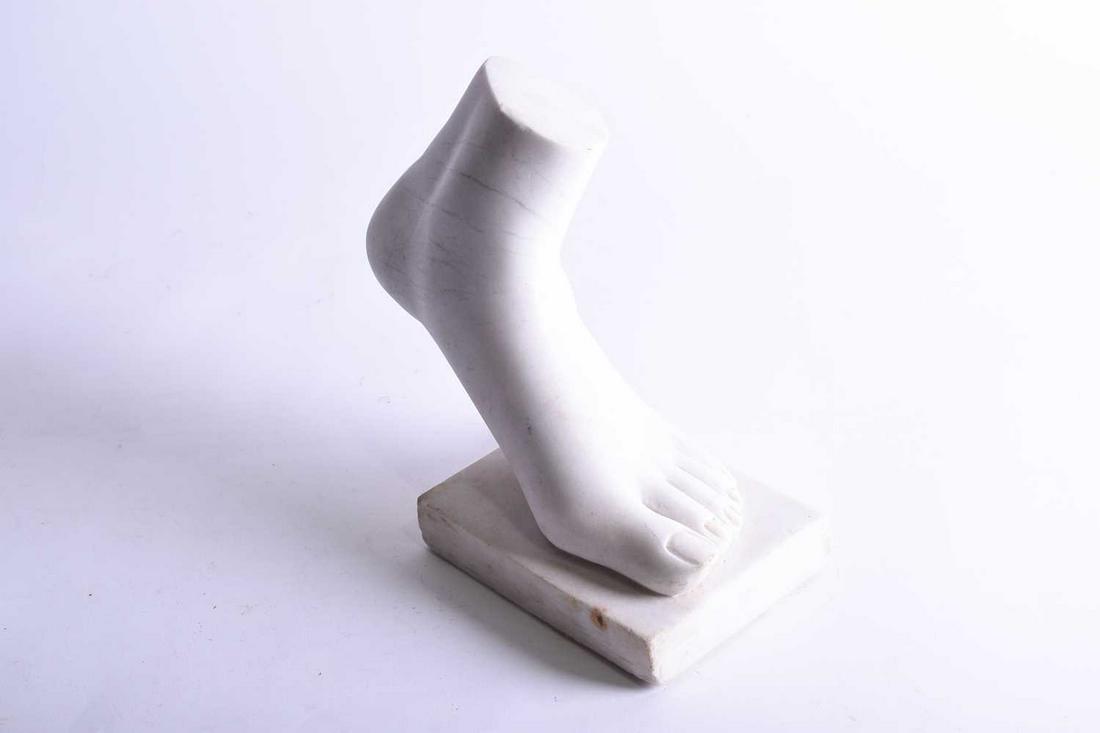 A Grand Tour style carved marble study of a foot,: A Grand Tour style carved marble study of a foot, probably 20th century, mounted to a rectangular base, 23.5 cm high x 26 cm wide.