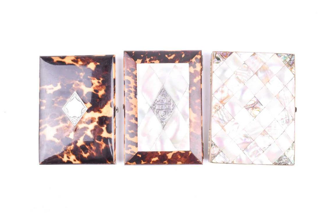 A late 19th century tortoiseshell card case, with blank: A late 19th century tortoiseshell card case, with blank diamond-shaped silver cartouche to centre, blue concertina lining with gilt edging, 10.5 x 7.5 cm, together with a tortoiseshell and mother-of-p