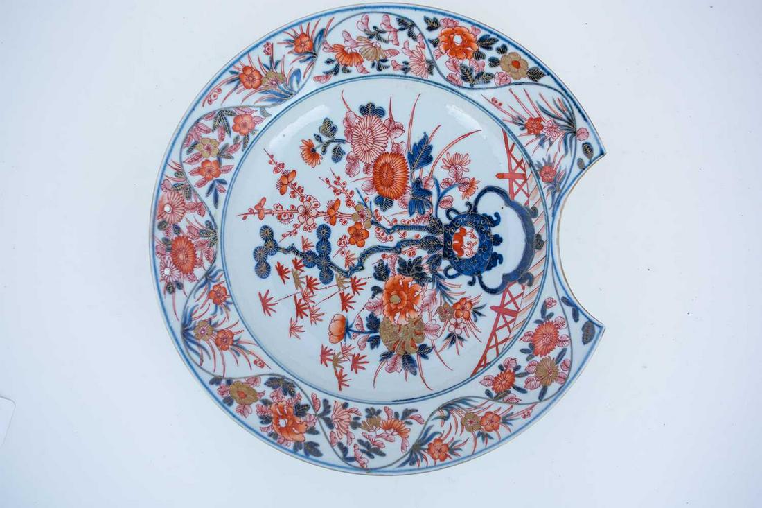 A Chinese Imari pattern barbers bowl, 18th century, the: A Chinese Imari pattern barbers bowl, 18th century, the centre painted with the three friends of winter Pine, Prunus & Bamboo, flanked by peony and chrysanthemums, the border with further flowers, hei