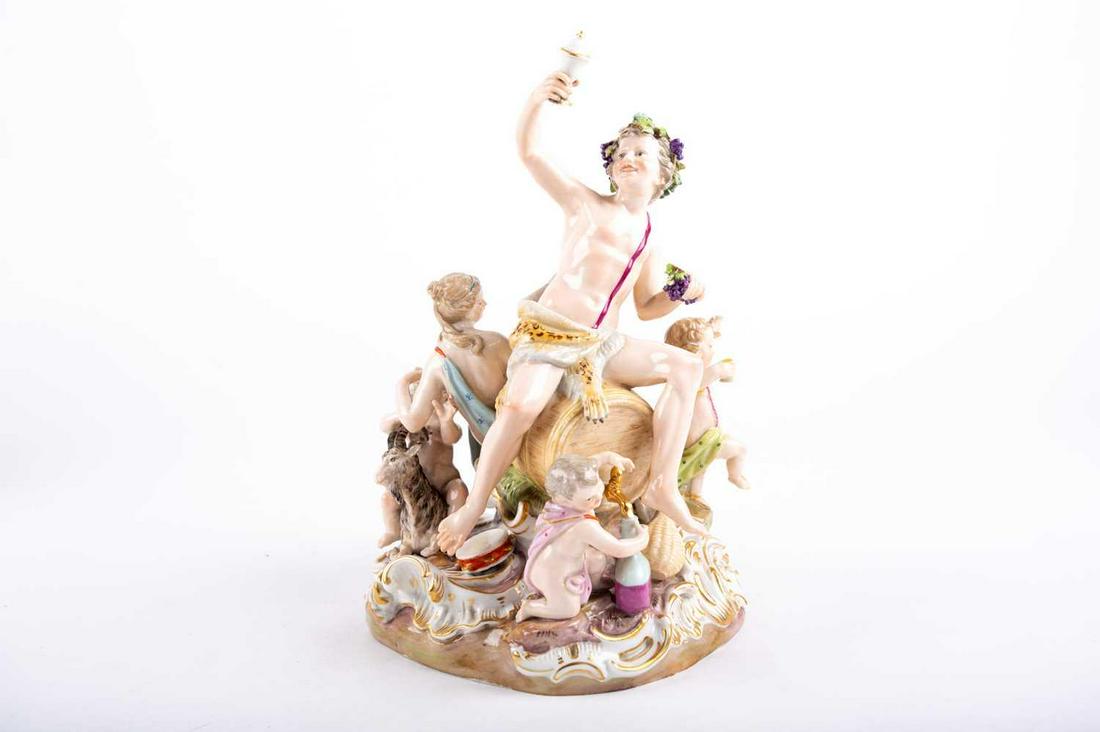 A fine19th century Meissen figure group of Bacchus with: A fine19th century Meissen figure group of Bacchus with children and a goat, he seated on a wine barrel and wearing a leopard skin, the whole supported on a scrolled rococo stle base, blue crossed swo